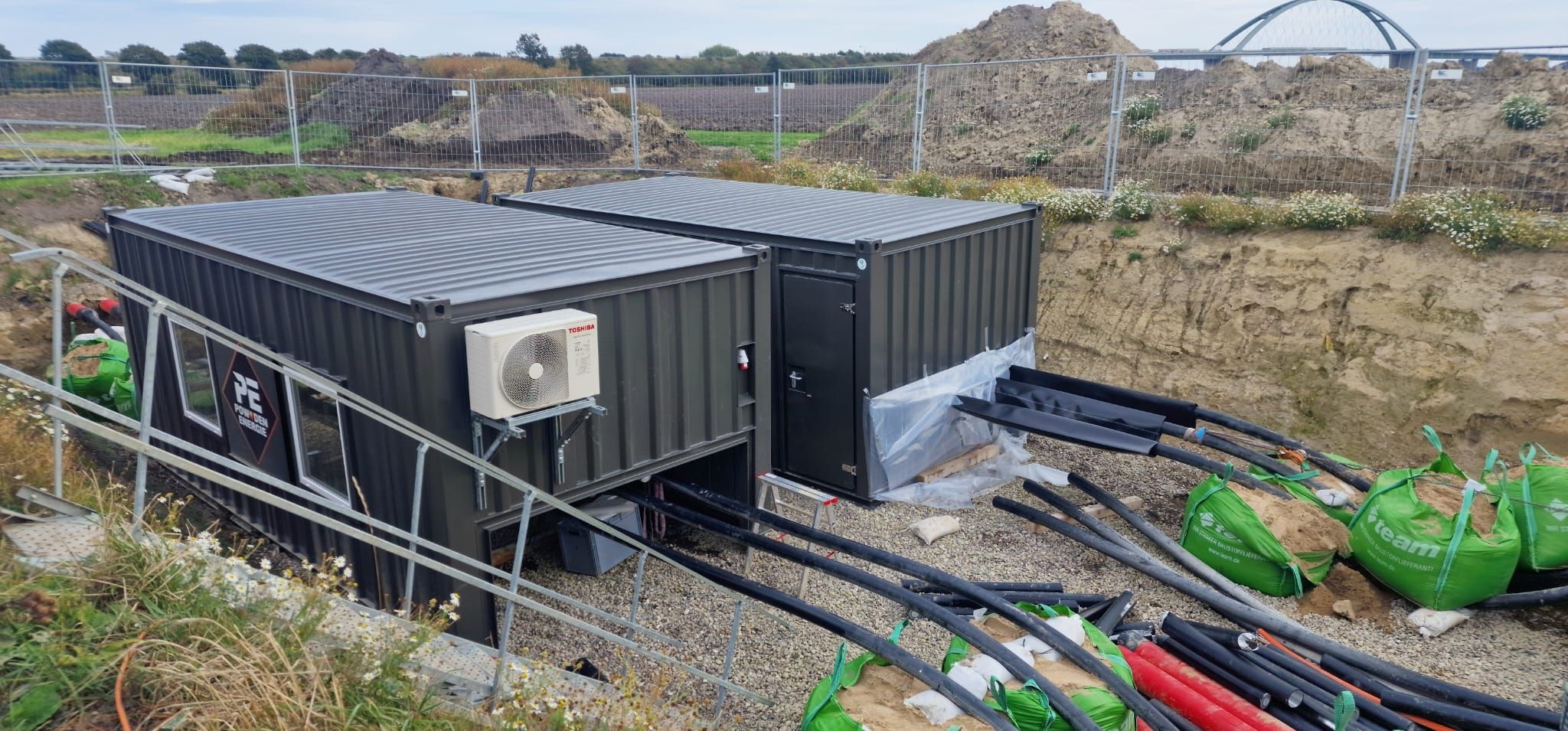 Two PE cable jointing containers beside a cable route