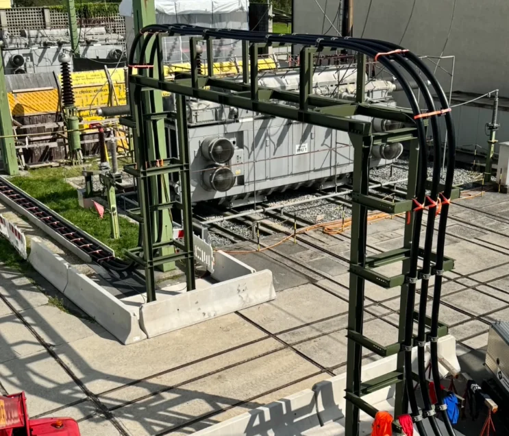 Steel cable bridge carrying high-voltage cables in a substation